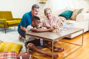 parents and their son playing Jenga in the living room