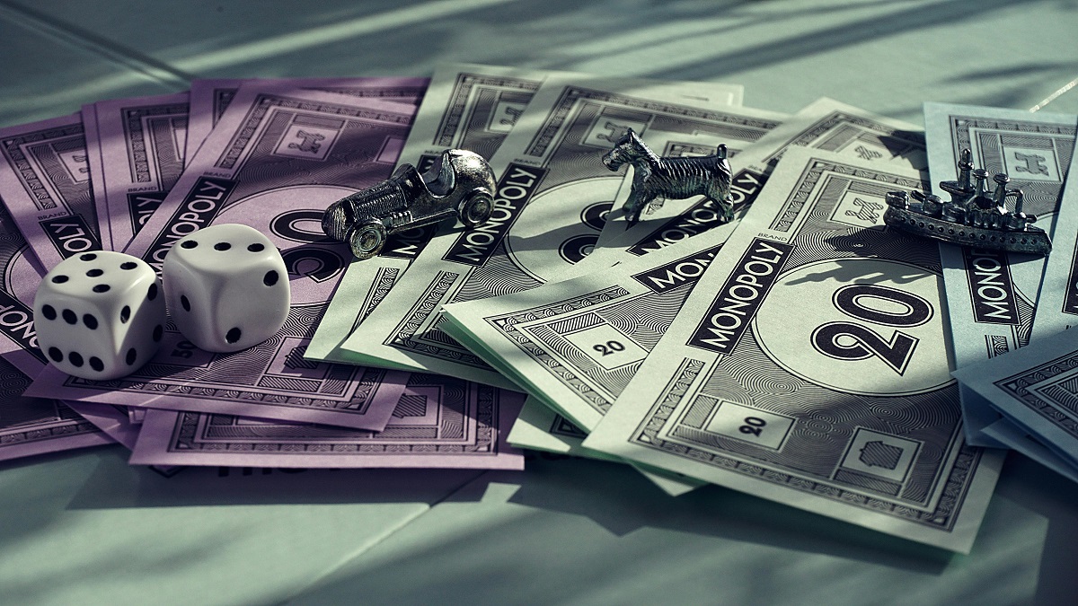 Monopoly bills, dice, and tokens scattered on a surface