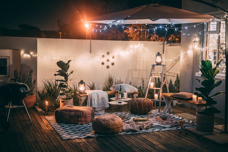 a patio with lighting and furniture