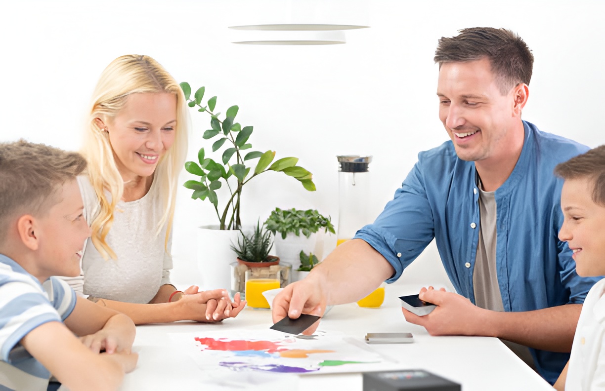 mom, dad, and kids playing a card game
